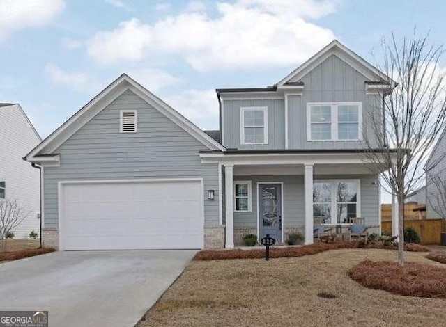 view of front of house featuring a garage and a front lawn