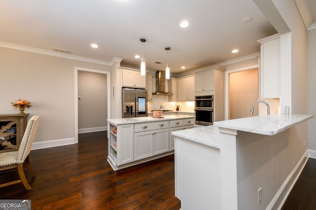 1560 Tapestry Rdg, Lawrenceville, GA 30045 - kitchen featuring stainless steel appliances, wall chimney range hood, a peninsula, dark wood finished floors, and crown molding