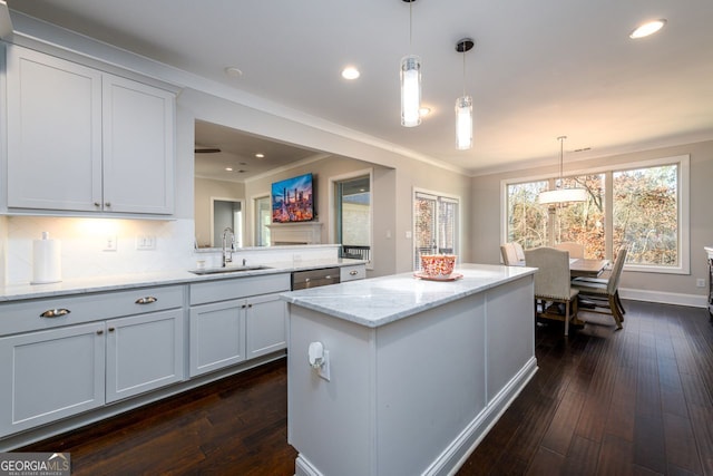 1560 Tapestry Rdg, Lawrenceville, GA 30045 - kitchen with dark wood-style floors, crown molding, stainless steel dishwasher, a center island, and hanging light fixtures