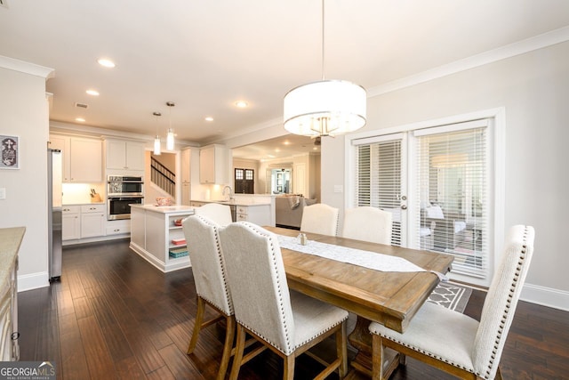1560 Tapestry Rdg, Lawrenceville, GA 30045 - dining space featuring ornamental molding, dark wood-style floors, recessed lighting, and a chandelier