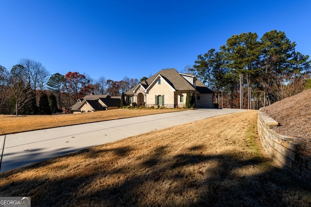 1560 Tapestry Rdg, Lawrenceville, GA 30045 - view of side of property featuring brick siding, driveway, and stone siding