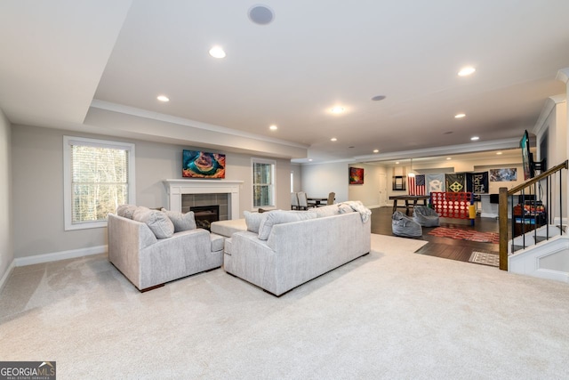 1560 Tapestry Rdg, Lawrenceville, GA 30045 - living area with a tile fireplace, crown molding, stairs, recessed lighting, and light colored carpet