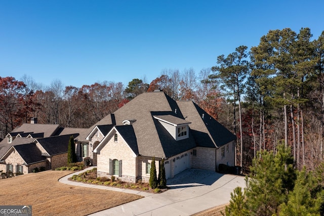 1560 Tapestry Rdg, Lawrenceville, GA 30045 - view of home's exterior featuring stone siding, concrete driveway, a shingled roof, and an attached garage