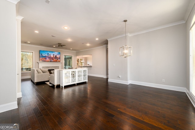 1560 Tapestry Rdg, Lawrenceville, GA 30045 - living area with crown molding, dark wood-type flooring, a fireplace, a chandelier, and recessed lighting