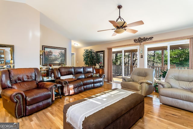 living room with lofted ceiling, light wood-style floors, and ceiling fan