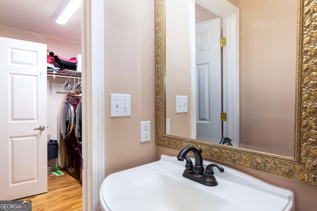 bathroom with wood finished floors and a sink