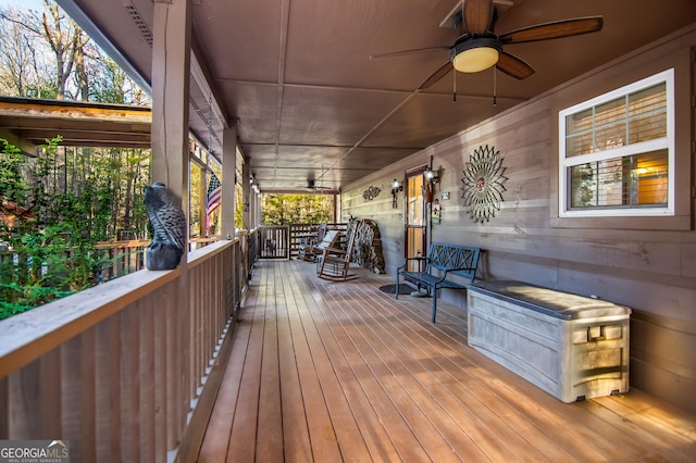 wooden deck featuring a porch and ceiling fan