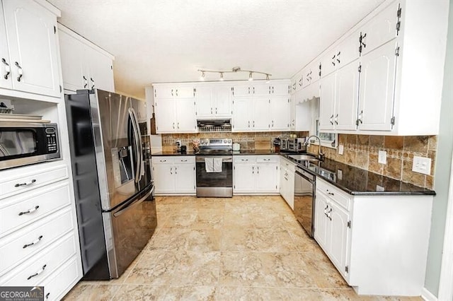 kitchen with backsplash, appliances with stainless steel finishes, sink, and white cabinets