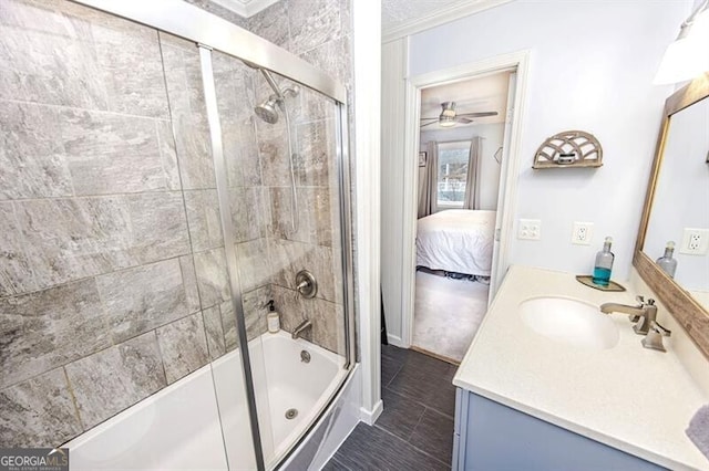 bathroom with crown molding, bath / shower combo with glass door, vanity, ceiling fan, and tile patterned flooring