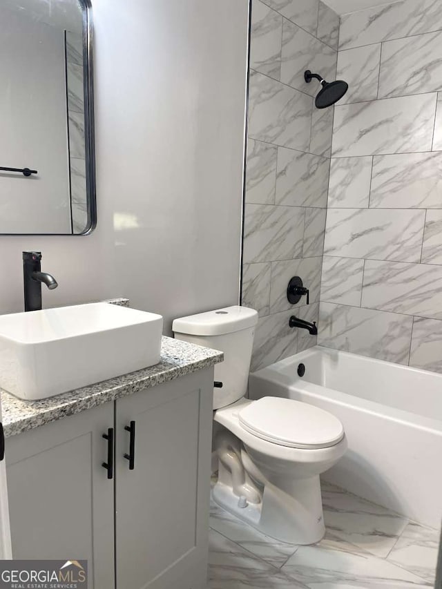 full bathroom with toilet, vanity, and tiled shower / bath combo