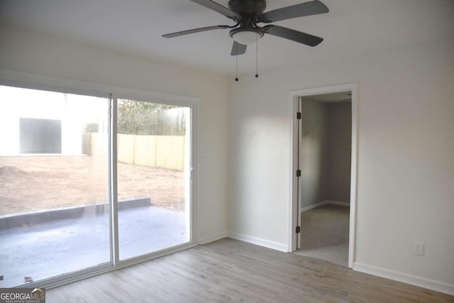 unfurnished room featuring light wood-type flooring and ceiling fan