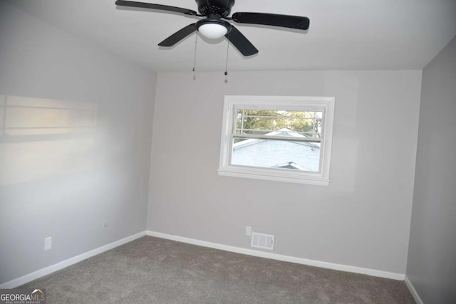 spare room featuring carpet flooring and ceiling fan