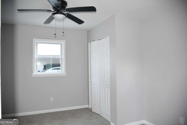 unfurnished bedroom featuring ceiling fan, light carpet, and a closet