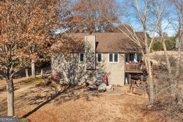 rear view of house with a wooden deck