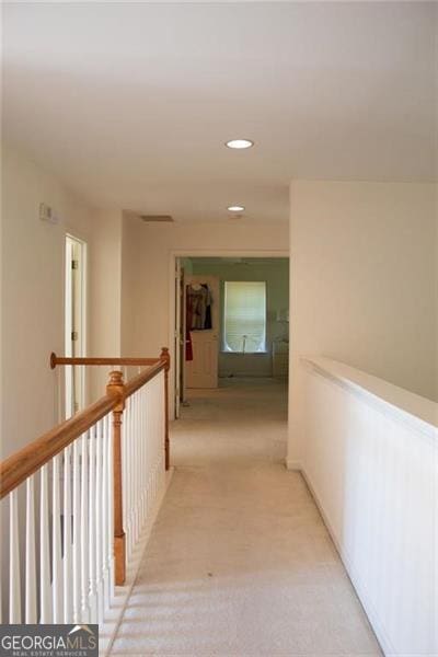 corridor with light colored carpet