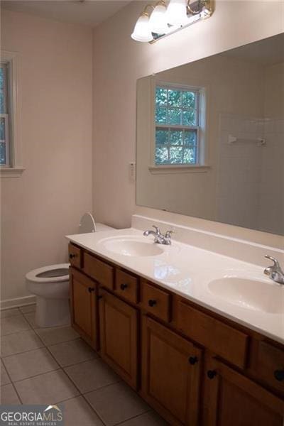 bathroom with tile patterned floors, vanity, and toilet