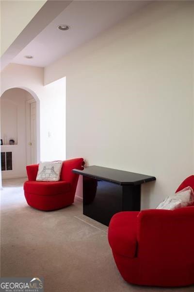 sitting room featuring light colored carpet