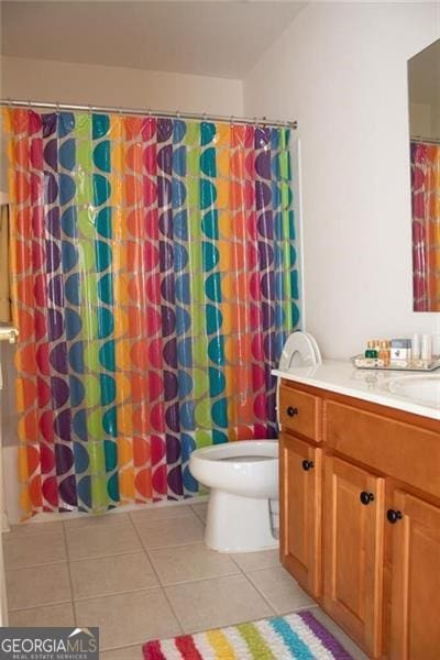 bathroom with tile patterned flooring, vanity, and toilet