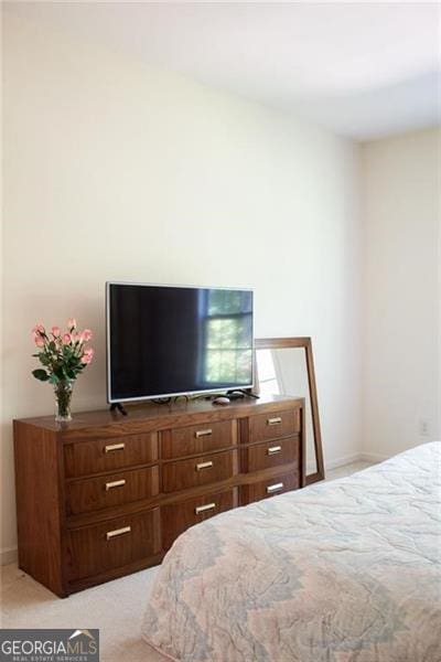 bedroom with light colored carpet