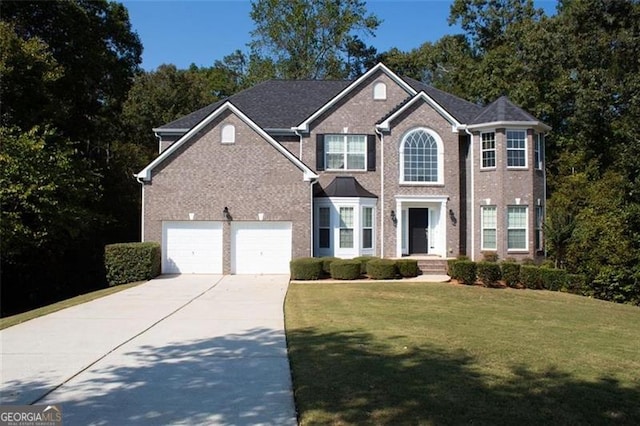 view of front of house featuring a garage and a front lawn