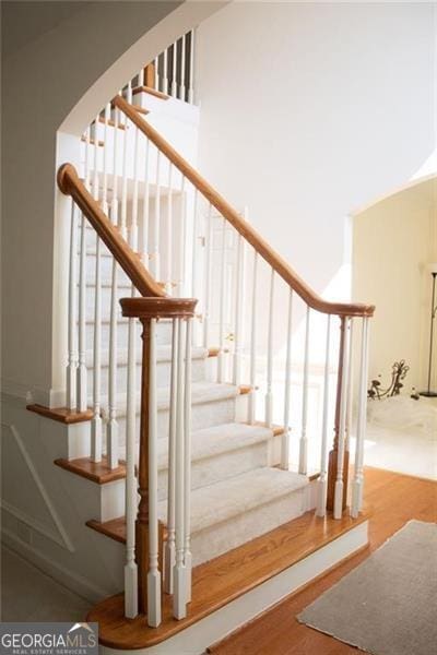 stairway featuring wood-type flooring