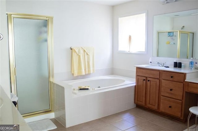 bathroom with tile patterned flooring, vanity, and shower with separate bathtub