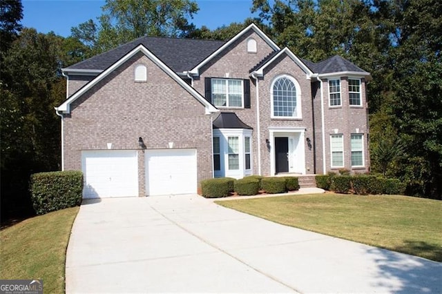 view of front of house featuring a garage and a front lawn