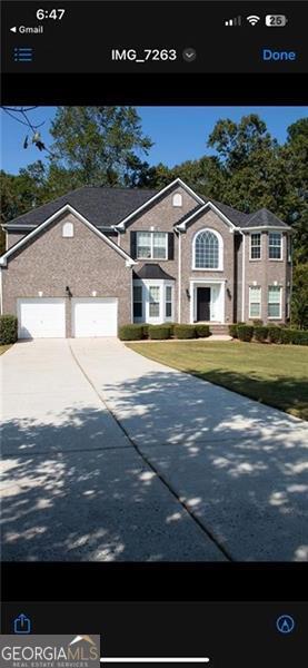 exterior space with a front yard and a garage