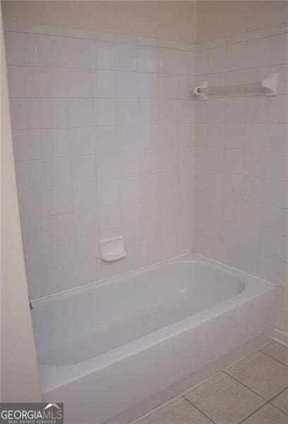 bathroom with tile patterned flooring and tiled shower / bath combo