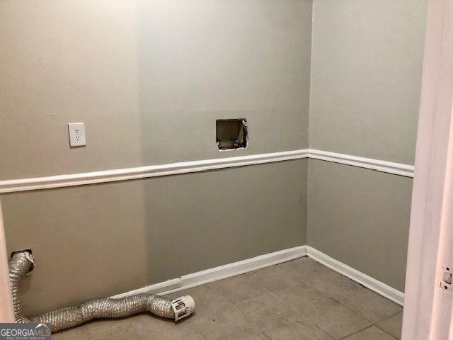 laundry room featuring hookup for an electric dryer, tile patterned floors, and hookup for a washing machine