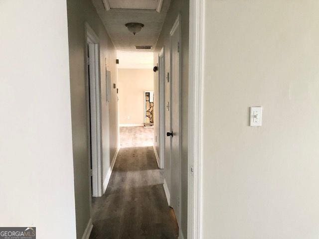 corridor featuring dark hardwood / wood-style flooring