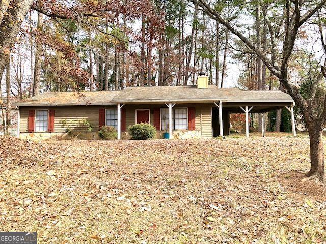 view of front of home with a carport