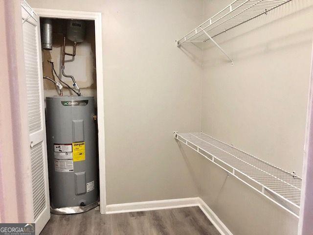 utility room featuring water heater