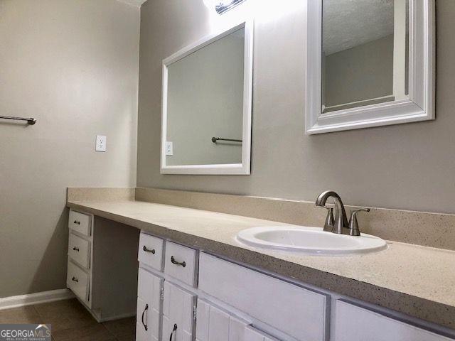 bathroom featuring tile patterned flooring and vanity