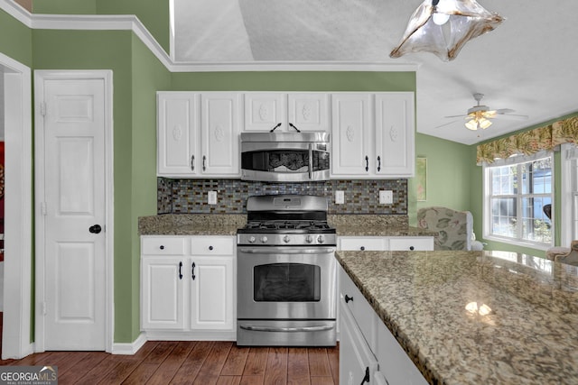 kitchen featuring stone counters, stainless steel appliances, and white cabinetry