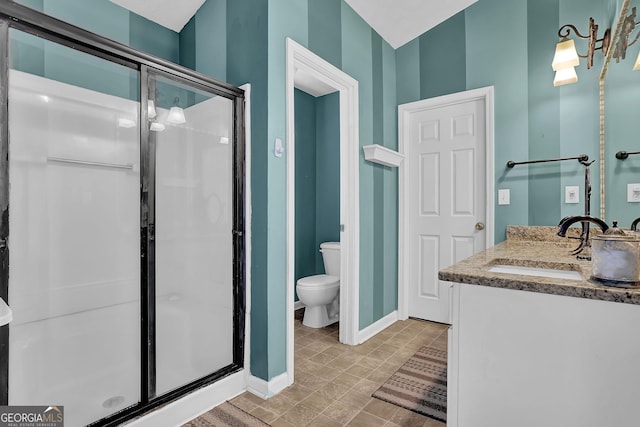 bathroom featuring vanity, toilet, and walk in shower