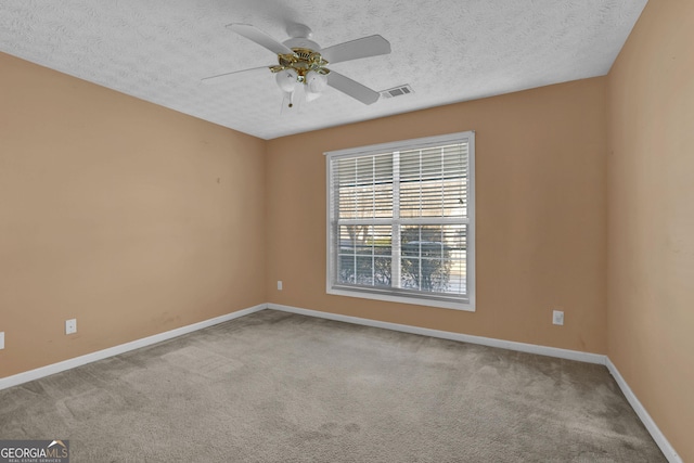 carpeted empty room with a textured ceiling and ceiling fan