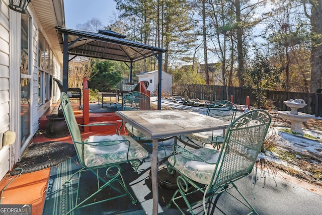 view of patio with a gazebo and a shed