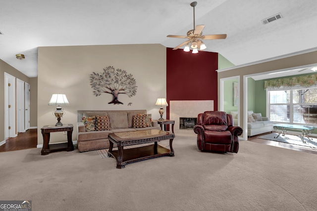 living room featuring carpet, ceiling fan, lofted ceiling, and a fireplace