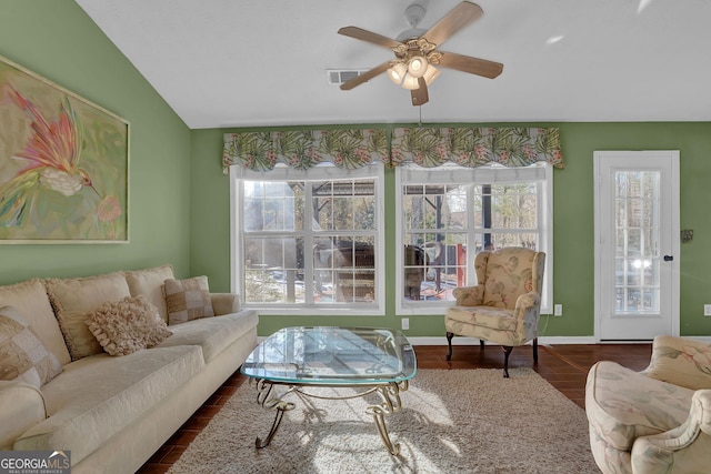 living room featuring ceiling fan, dark hardwood / wood-style flooring, plenty of natural light, and vaulted ceiling