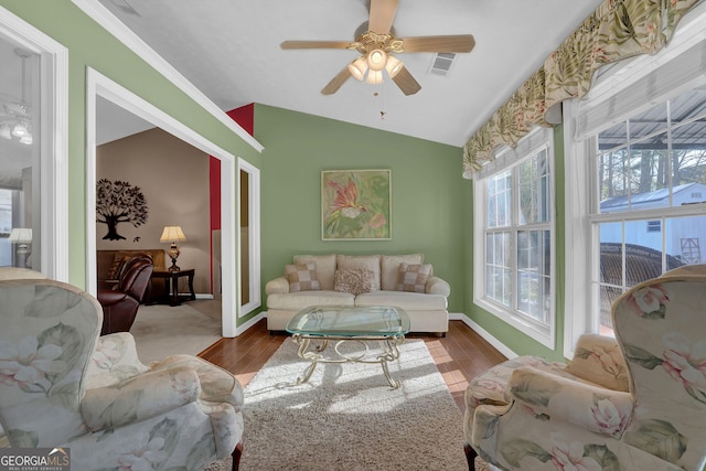 living room featuring ceiling fan, lofted ceiling, and hardwood / wood-style flooring