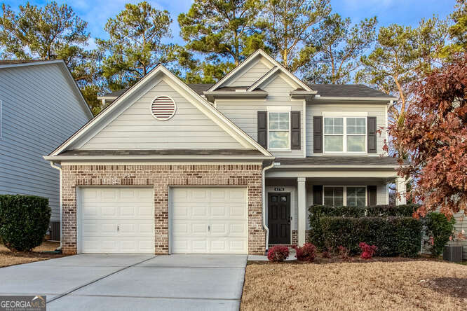 craftsman-style home with central AC and a garage