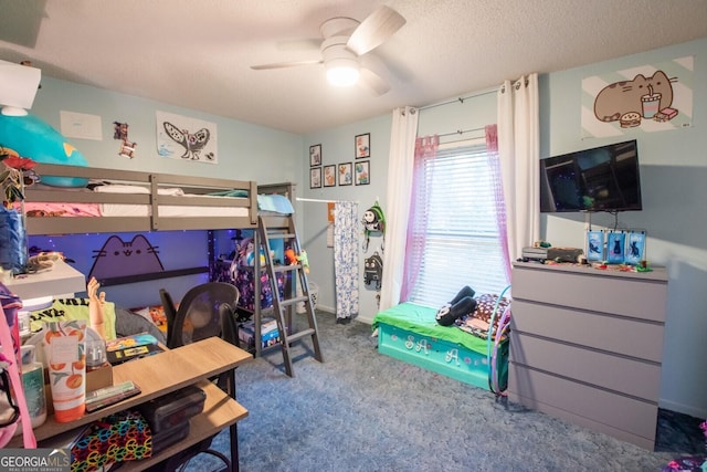 bedroom with ceiling fan, carpet, and a textured ceiling