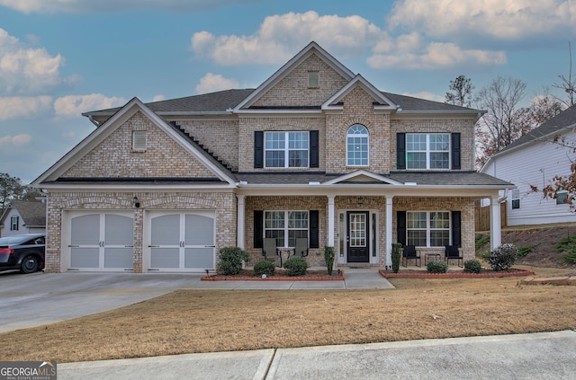 craftsman house with a garage, a front lawn, and covered porch