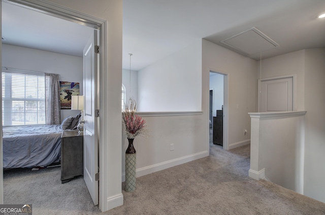 hallway with light colored carpet