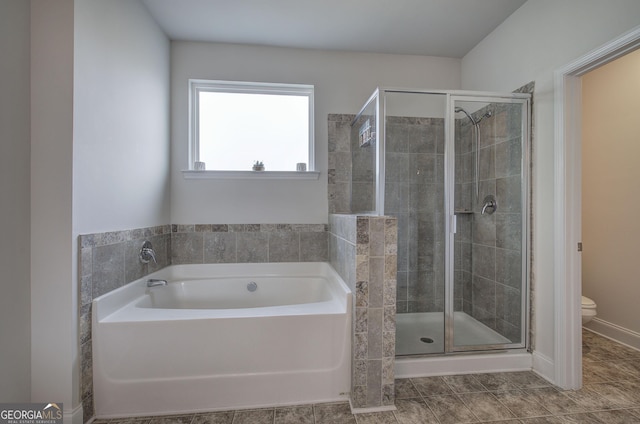 bathroom with tile patterned flooring, separate shower and tub, and toilet