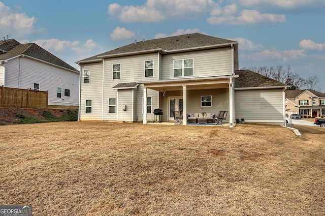 back of property featuring a yard and a patio area