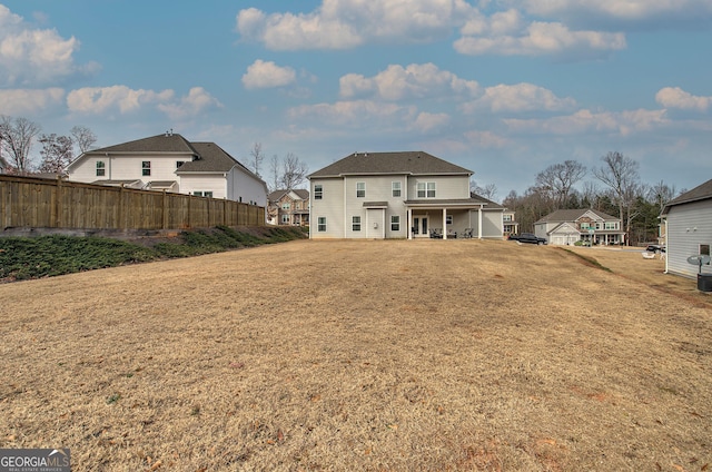 back of property featuring a yard