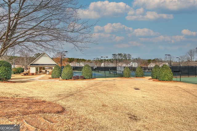 surrounding community featuring tennis court