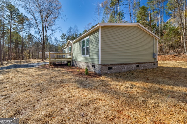 view of side of home with a deck